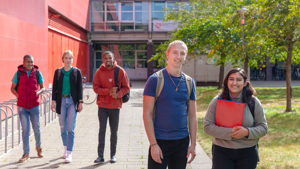 Students walking along the MZH and chatting